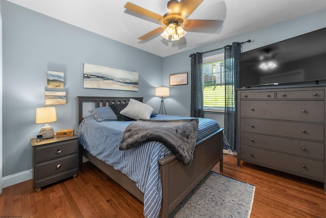 bedroom with ceiling fan and dark hardwood / wood-style flooring