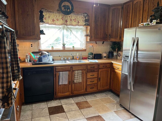 kitchen featuring dishwasher, tasteful backsplash, stainless steel fridge with ice dispenser, and sink