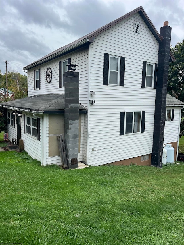 rear view of property with a yard