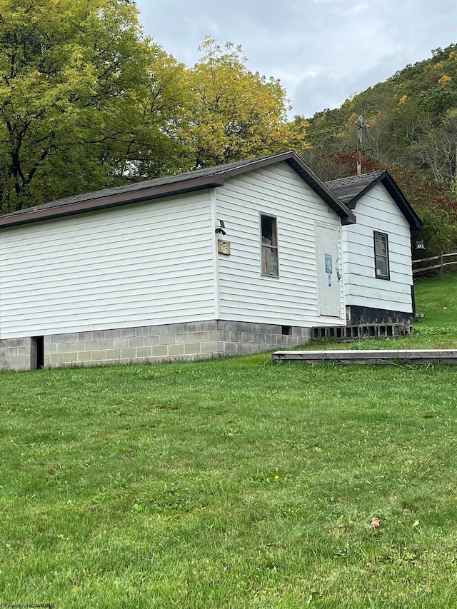 view of property exterior with a yard