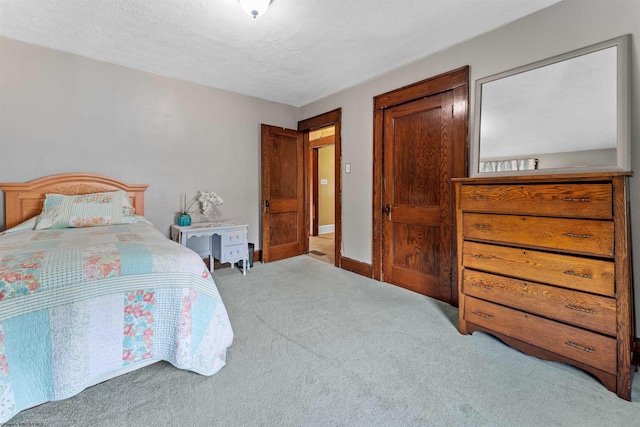 carpeted bedroom with a textured ceiling