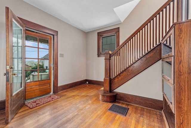 entryway with hardwood / wood-style floors