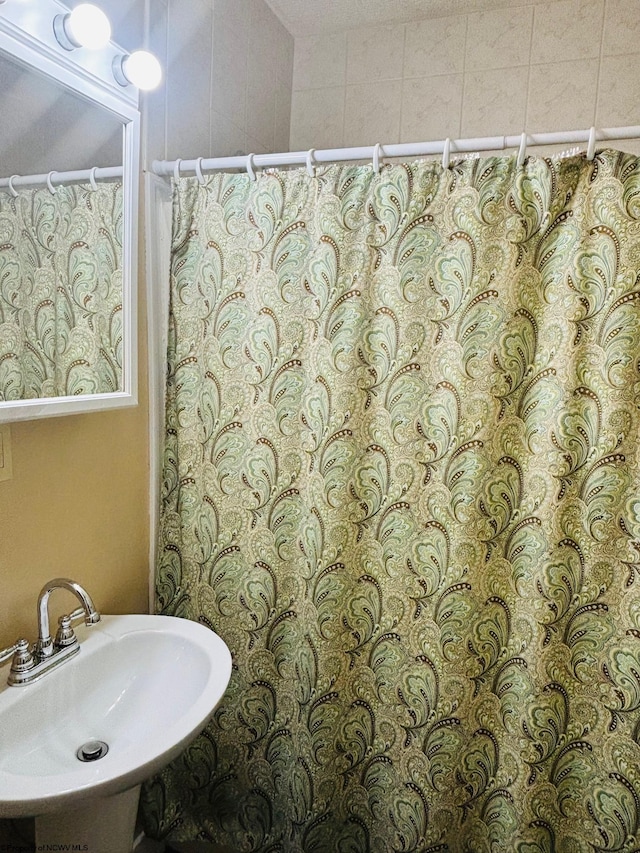 bathroom featuring sink and a shower with shower curtain