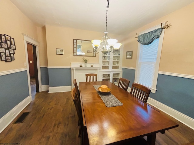 dining area featuring a chandelier and dark hardwood / wood-style floors