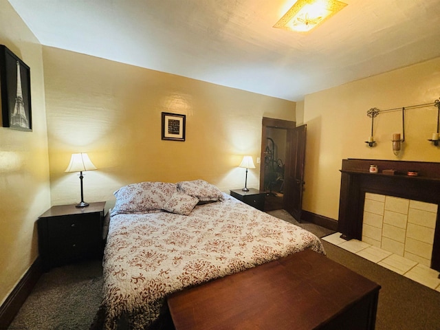 carpeted bedroom with a fireplace