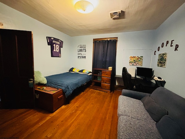 bedroom with hardwood / wood-style flooring