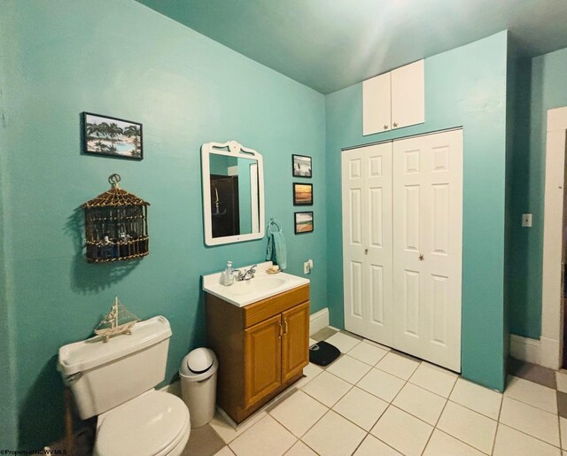 bathroom with vanity, tile patterned flooring, and toilet