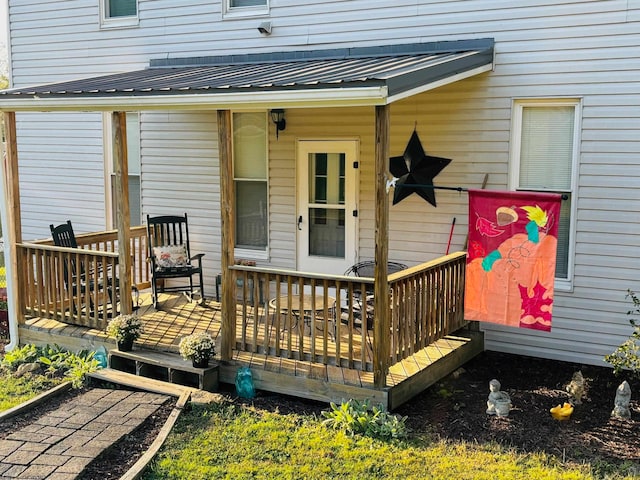 view of exterior entry featuring a wooden deck