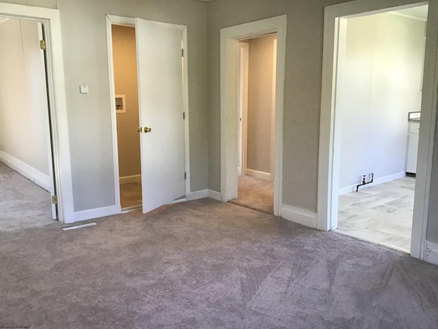 unfurnished bedroom with light colored carpet