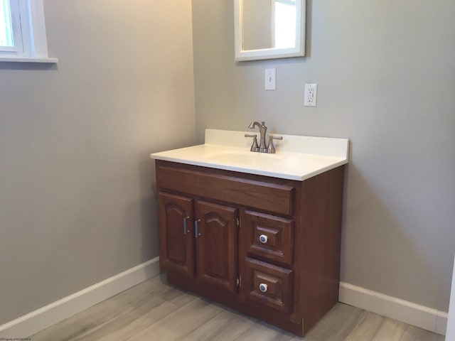 bathroom with wood-type flooring and vanity