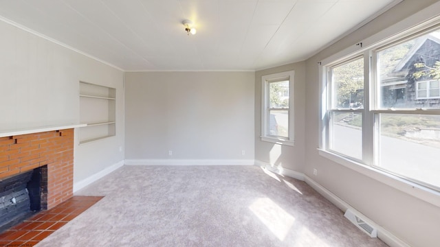 unfurnished living room featuring a brick fireplace, carpet, and built in features