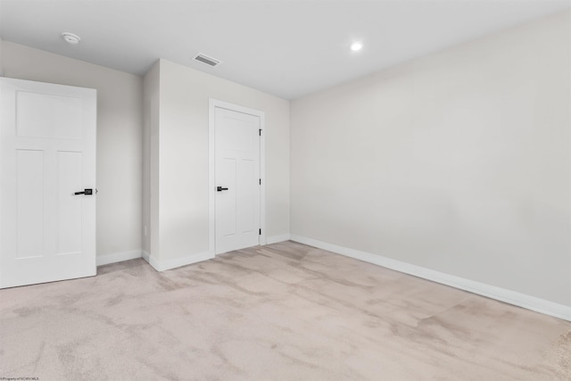 unfurnished room with light carpet