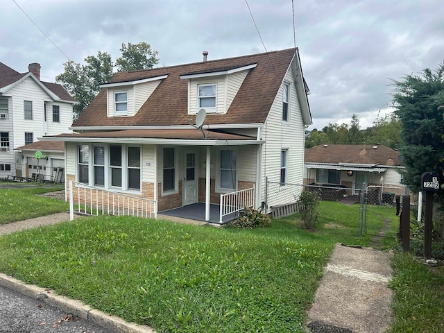 view of front of house featuring a front yard and a porch