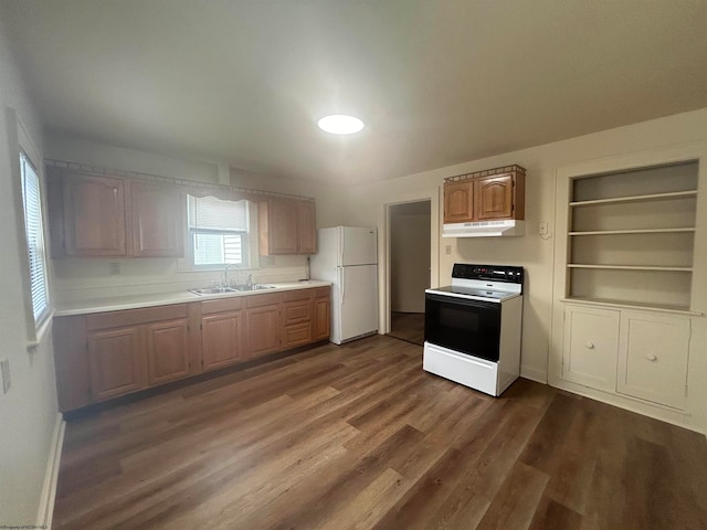 kitchen featuring built in shelves, white appliances, sink, and dark hardwood / wood-style flooring