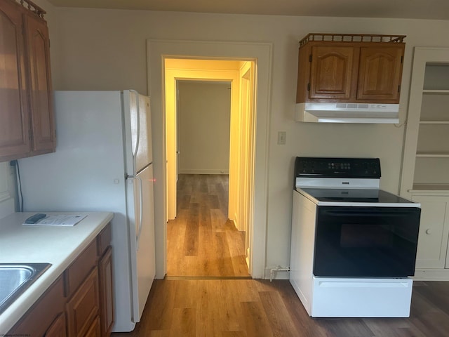 kitchen with light hardwood / wood-style flooring and white appliances