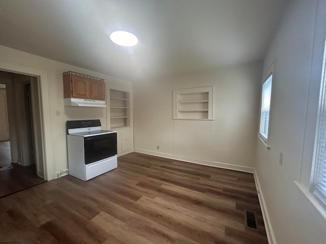 kitchen with white range oven, built in shelves, and dark hardwood / wood-style flooring