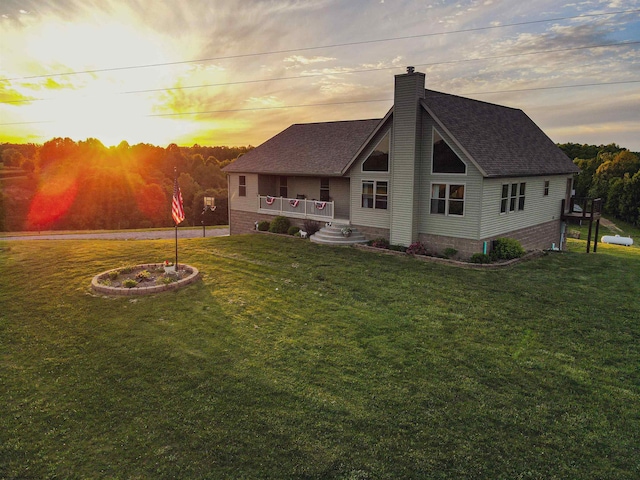 back house at dusk with a lawn