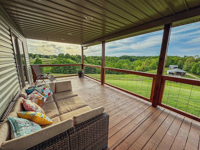 wooden deck with outdoor lounge area and a yard