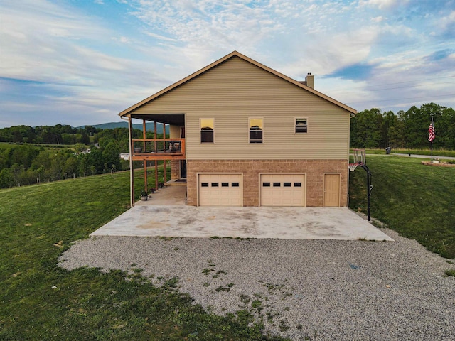 view of side of property with a garage and a yard