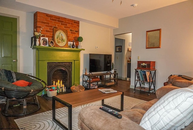 living room with dark hardwood / wood-style flooring and a large fireplace