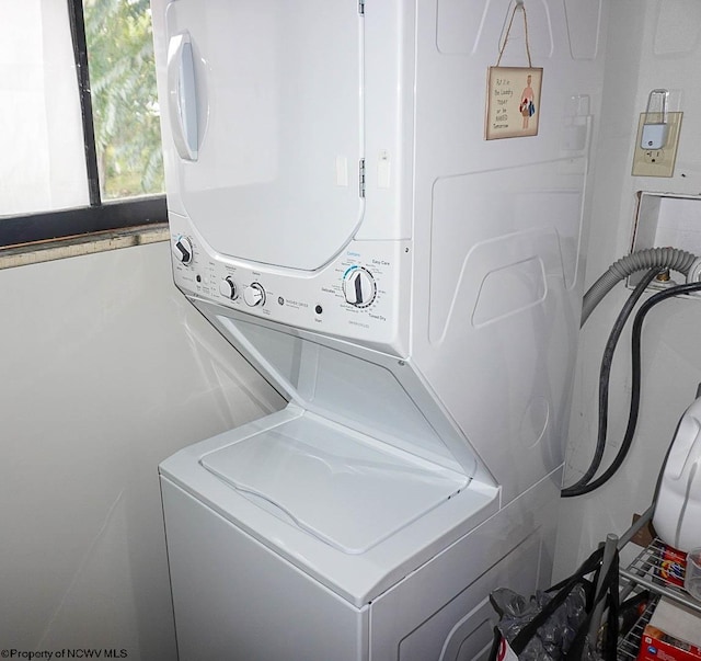 laundry room with stacked washer and clothes dryer