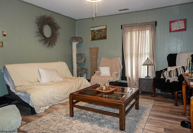 living room featuring crown molding and hardwood / wood-style floors