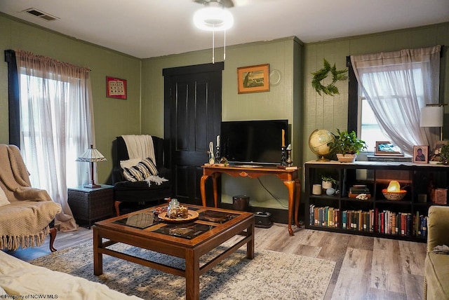 living room featuring ceiling fan and light hardwood / wood-style floors