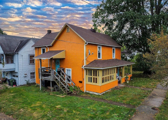 back house at dusk with a yard