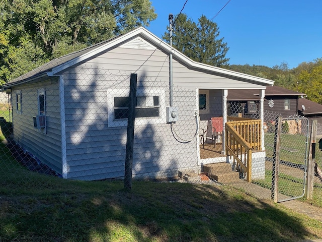 view of home's exterior featuring cooling unit and a lawn