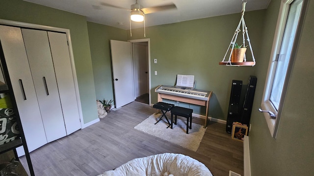 misc room with ceiling fan and wood-type flooring