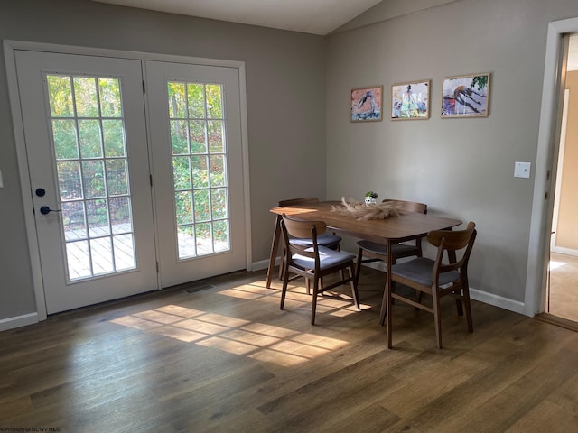 dining area with dark wood-type flooring and french doors