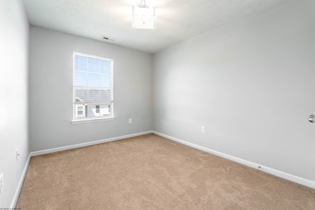 unfurnished room featuring light colored carpet