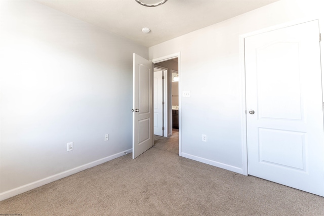 unfurnished bedroom with light colored carpet