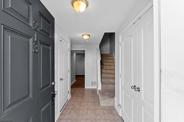 entryway with a textured ceiling