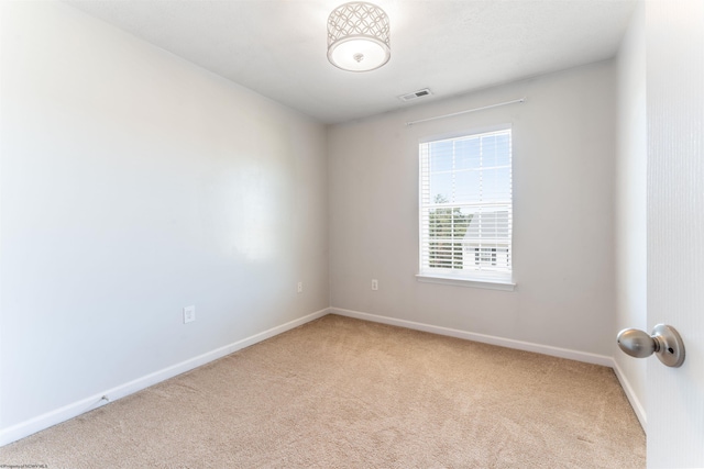 unfurnished room with light colored carpet