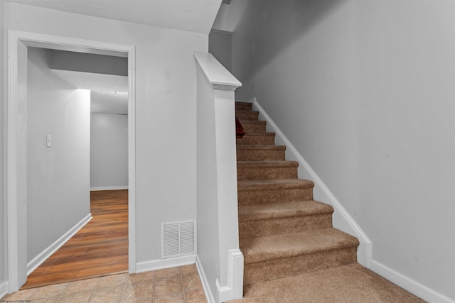 stairs with hardwood / wood-style floors