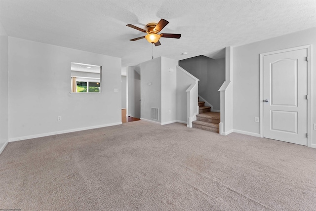 unfurnished living room with light carpet, a textured ceiling, and ceiling fan