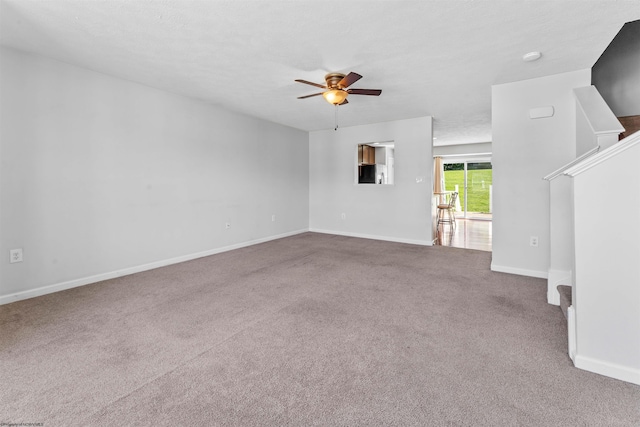 unfurnished living room with carpet floors, a textured ceiling, and ceiling fan