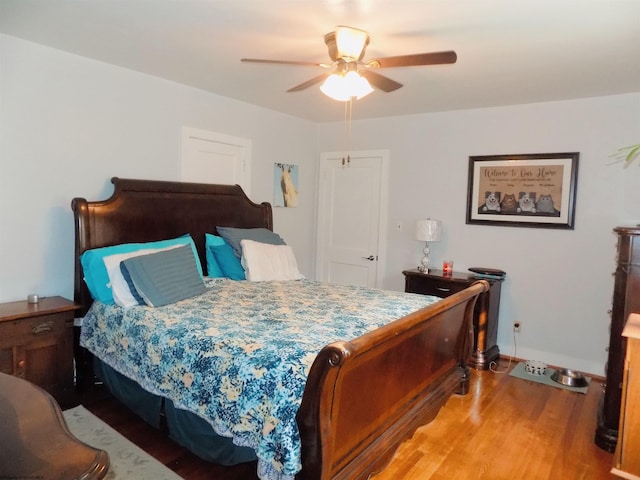 bedroom featuring hardwood / wood-style floors and ceiling fan