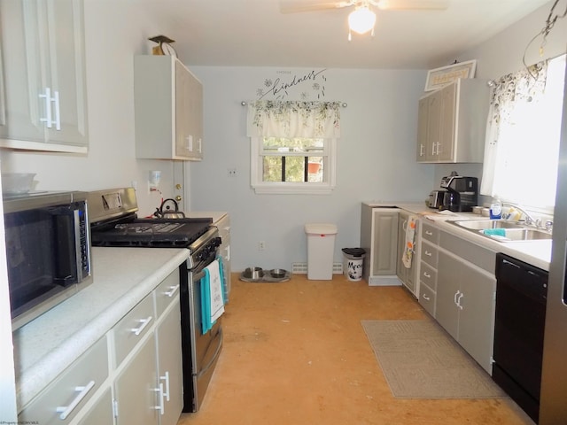 kitchen with appliances with stainless steel finishes, sink, gray cabinetry, and ceiling fan