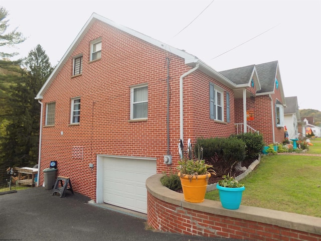 view of home's exterior featuring a yard and a garage