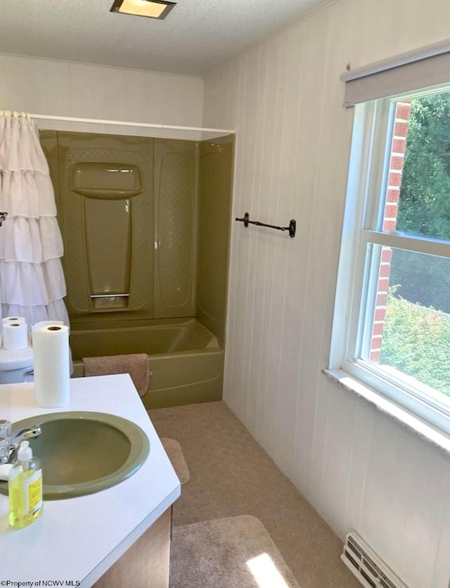 bathroom with vanity, a baseboard radiator, and shower / bathtub combination with curtain