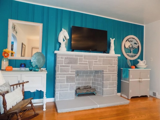 interior space with a stone fireplace and light hardwood / wood-style floors