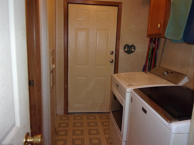 laundry room featuring independent washer and dryer and cabinets