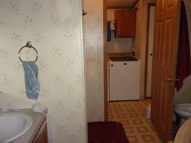 bathroom with vanity, washer / clothes dryer, and toilet