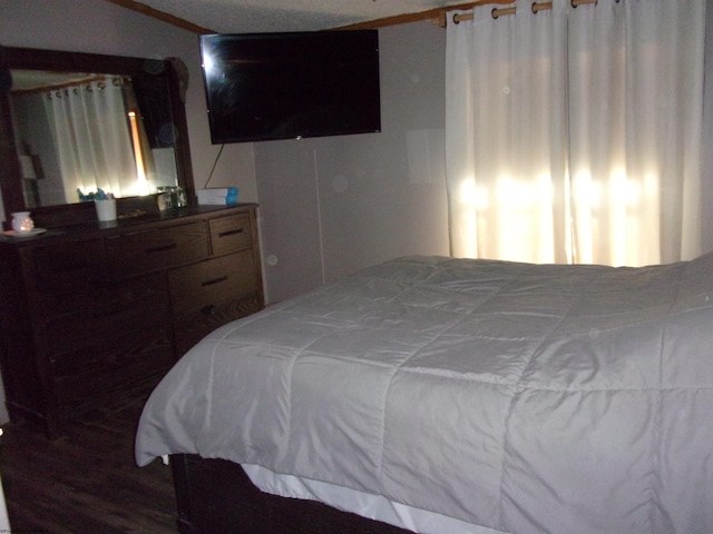 bedroom featuring ornamental molding and wood-type flooring