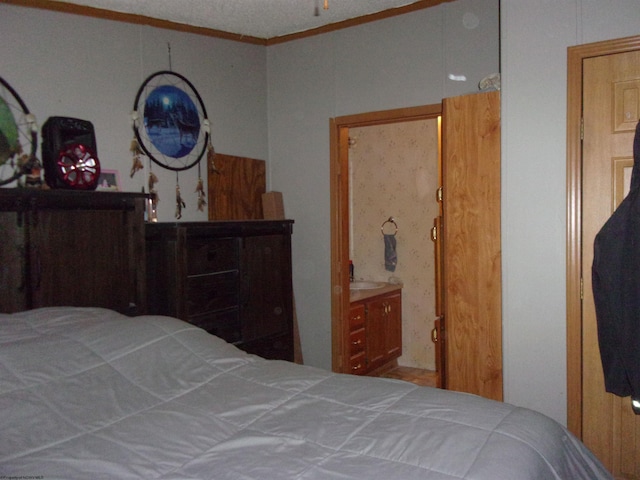 bedroom featuring crown molding and ensuite bath