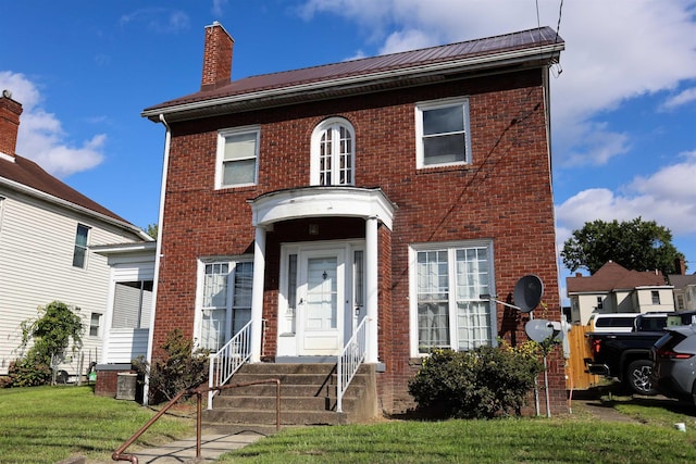 view of front of house featuring central air condition unit and a front lawn