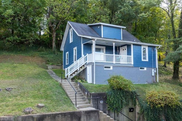 view of front of home featuring a garage, a front lawn, and a porch