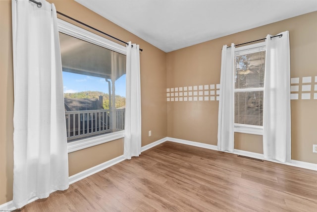 spare room featuring light wood-type flooring